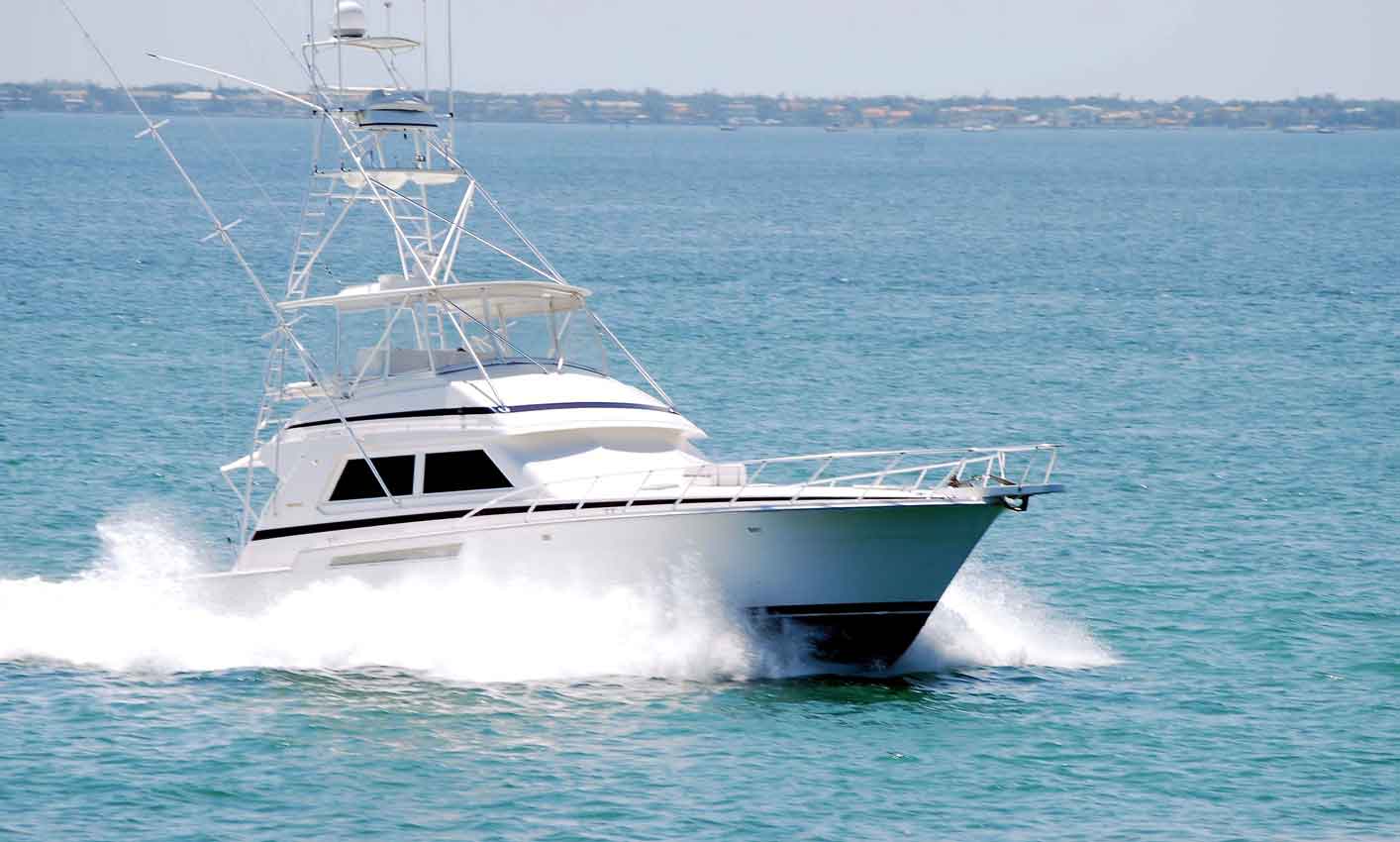 white sport fishing boat sailing on biscayne bay’s waters